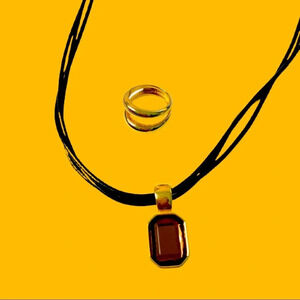 Joan Rivers necklace and ring. Gold color leather.